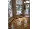 Inviting breakfast nook with hardwood floors and large windows offering serene views of the surrounding landscape at 102 Preston Pines Dr, Cary, NC 27513