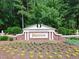 Entrance to the Preston community, featuring a brick sign and landscaping at 102 Preston Pines Dr, Cary, NC 27513