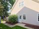 Exterior view of the home, showing the side entrance and well-kept lawn at 102 Preston Pines Dr, Cary, NC 27513