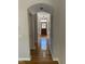 Elegant hallway with gleaming hardwood floors leading to a beautifully detailed front door at 102 Preston Pines Dr, Cary, NC 27513