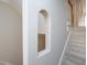 Hallway featuring arched wall decor with a view of the carpeted staircase at 102 Preston Pines Dr, Cary, NC 27513
