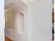 Hallway with an arched design and hardwood floors at 102 Preston Pines Dr, Cary, NC 27513