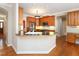 Well-lit kitchen featuring wood cabinets, stainless steel appliances, and a peninsula with bar seating at 102 Preston Pines Dr, Cary, NC 27513
