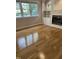 Bright living room featuring hardwood floors, a fireplace, and built-in shelving at 102 Preston Pines Dr, Cary, NC 27513