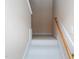 Image of a simple, carpeted staircase with a wooden handrail at 102 Preston Pines Dr, Cary, NC 27513