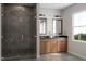 Contemporary bathroom featuring double sinks, wood cabinets, and a sleek glass-enclosed shower at 1206 Holding Village Way, Wake Forest, NC 27587