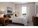 Relaxing bedroom features a black metal bed frame, two side tables, and a large window with sheer curtains at 1206 Holding Village Way, Wake Forest, NC 27587