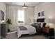 Modern bedroom with a large window, striped curtains, a dark bed frame, and neutral color scheme at 1206 Holding Village Way, Wake Forest, NC 27587