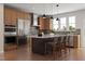 Modern kitchen featuring stainless steel appliances, a center island with seating, and ample cabinet space at 1206 Holding Village Way, Wake Forest, NC 27587