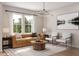 Inviting living room with a comfortable sofa, two armchairs, a coffee table, and a large window at 1206 Holding Village Way, Wake Forest, NC 27587