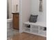 Entryway with a built-in bench, storage shelves, and a view into a bathroom with a wood vanity at 1206 Holding Village Way, Wake Forest, NC 27587