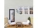 Outdoor patio with two chairs, a small table with a chess set, and white siding with black trim at 1206 Holding Village Way, Wake Forest, NC 27587