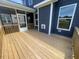 Spacious wooden back deck featuring a screened porch and modern home exterior at 1528 Maelyn Way, Fuquay Varina, NC 27526