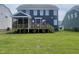 New home featuring a deck, covered patio, and large yard at 1528 Maelyn Way, Fuquay Varina, NC 27526