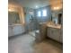 Primary bathroom boasts a glass-door shower and double sinks with tile floor at 1528 Maelyn Way, Fuquay Varina, NC 27526