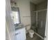 Updated bathroom featuring a glass-door shower, white cabinets and sleek fixtures at 1528 Maelyn Way, Fuquay Varina, NC 27526