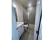 Modern bathroom features a glass-enclosed shower, gray tile, and a white vanity with a granite countertop at 1528 Maelyn Way, Fuquay Varina, NC 27526