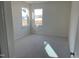 Bright bedroom with two windows providing ample natural light and neutral carpet at 1528 Maelyn Way, Fuquay Varina, NC 27526