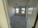 Bright bedroom with carpet flooring and two large windows at 1528 Maelyn Way, Fuquay Varina, NC 27526
