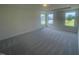 Spacious bedroom with neutral carpet and three bright windows at 1528 Maelyn Way, Fuquay Varina, NC 27526