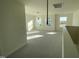 Large bonus room with neutral carpet, bright windows, and lots of natural light at 1528 Maelyn Way, Fuquay Varina, NC 27526