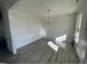 Spacious dining room with wood-look floors and a modern chandelier at 1528 Maelyn Way, Fuquay Varina, NC 27526