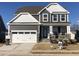 Charming two-story home with a gray exterior, white trim, and a two-car garage on a sunny day at 1528 Maelyn Way, Fuquay Varina, NC 27526