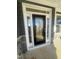 Elegant front door with glass panels, white trim, and stone accents creating an inviting entrance at 1528 Maelyn Way, Fuquay Varina, NC 27526