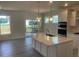 Bright kitchen boasts a large island, stainless appliances, and a view of the outdoor deck at 1528 Maelyn Way, Fuquay Varina, NC 27526