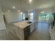Bright, open kitchen with a large island, stainless steel appliances, and sliding glass doors to the backyard at 1528 Maelyn Way, Fuquay Varina, NC 27526