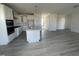 Open concept kitchen with white cabinets and a large island at 1528 Maelyn Way, Fuquay Varina, NC 27526