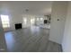 Open living room with hardwood floors and fireplace, leading to kitchen and back patio at 1528 Maelyn Way, Fuquay Varina, NC 27526