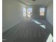 Spacious main bedroom with carpeted floors and large windows providing abundant natural light at 1528 Maelyn Way, Fuquay Varina, NC 27526
