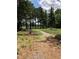 Community playground with swing set and mulch foundation surrounded by beautiful tall pine trees at 1528 Maelyn Way, Fuquay Varina, NC 27526