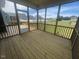 Enjoy this screened porch with wood floors and backyard views at 1528 Maelyn Way, Fuquay Varina, NC 27526