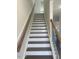 Clean staircase with wooden handrails and white risers, leading to the upper level at 1528 Maelyn Way, Fuquay Varina, NC 27526
