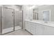 Modern bathroom boasts double vanity, a glass enclosed shower, and bright natural lighting at 240 Sequoia Dr, Louisburg, NC 27549