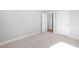 Carpeted bedroom with two doors and neutral walls at 240 Sequoia Dr, Louisburg, NC 27549