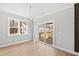 Bright dining area with sliding glass doors to the backyard deck and a modern chandelier at 240 Sequoia Dr, Louisburg, NC 27549
