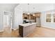 Modern kitchen with an island, stainless steel appliances, and ample counter space and natural light at 240 Sequoia Dr, Louisburg, NC 27549