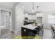 Modern kitchen with an island, white cabinets, and dark countertops at 240 Sequoia Dr, Louisburg, NC 27549