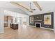 Spacious living room with vaulted ceiling, fireplace, and an open floor plan into the modern kitchen at 240 Sequoia Dr, Louisburg, NC 27549