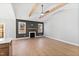 Bright living room features vaulted ceilings, wood beam accents, and a cozy fireplace with a mantle at 240 Sequoia Dr, Louisburg, NC 27549