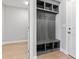 Mudroom with a gray storage bench, hooks, and wood-look flooring at 240 Sequoia Dr, Louisburg, NC 27549