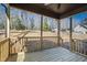 A covered porch with wooden floors, a railing, and a view of the backyard at 240 Sequoia Dr, Louisburg, NC 27549