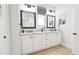 Elegant bathroom with dual sinks, framed mirrors, and plenty of storage space at 2408 Adrift Road, Fuquay Varina, NC 27526
