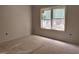 A simple bedroom design with white walls, trim, and window covered in protective plastic at 2408 Adrift Road, Fuquay Varina, NC 27526
