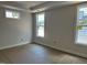 Bright bedroom featuring tray ceiling and large windows at 2408 Adrift Road, Fuquay Varina, NC 27526