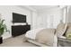 Spacious bedroom with a dark dresser, a large TV, and a comfortable bed at 2408 Adrift Road, Fuquay Varina, NC 27526