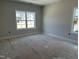 Bright bedroom featuring large windows offering abundant natural light at 2408 Adrift Road, Fuquay Varina, NC 27526